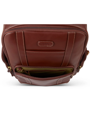 A close-up view of a brown leather handbag showcasing detailed stitching, a central brand label, and a partially open zipper that reveals a green interior lining, complemented by gold-toned hardware.