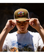 close up of male model wearing Brown cap with white mesh back and Yak & Yeti building patch in center