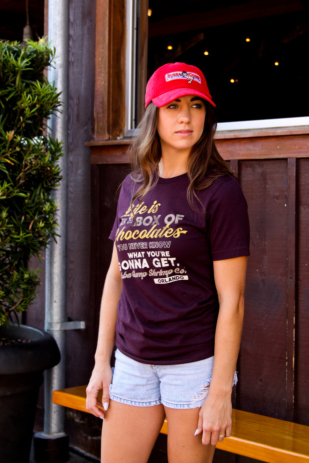 Woman wearing limited edition red Bubba Gump cap with "Life is Like a Box of Chocolates" tee from Bubba Gump.